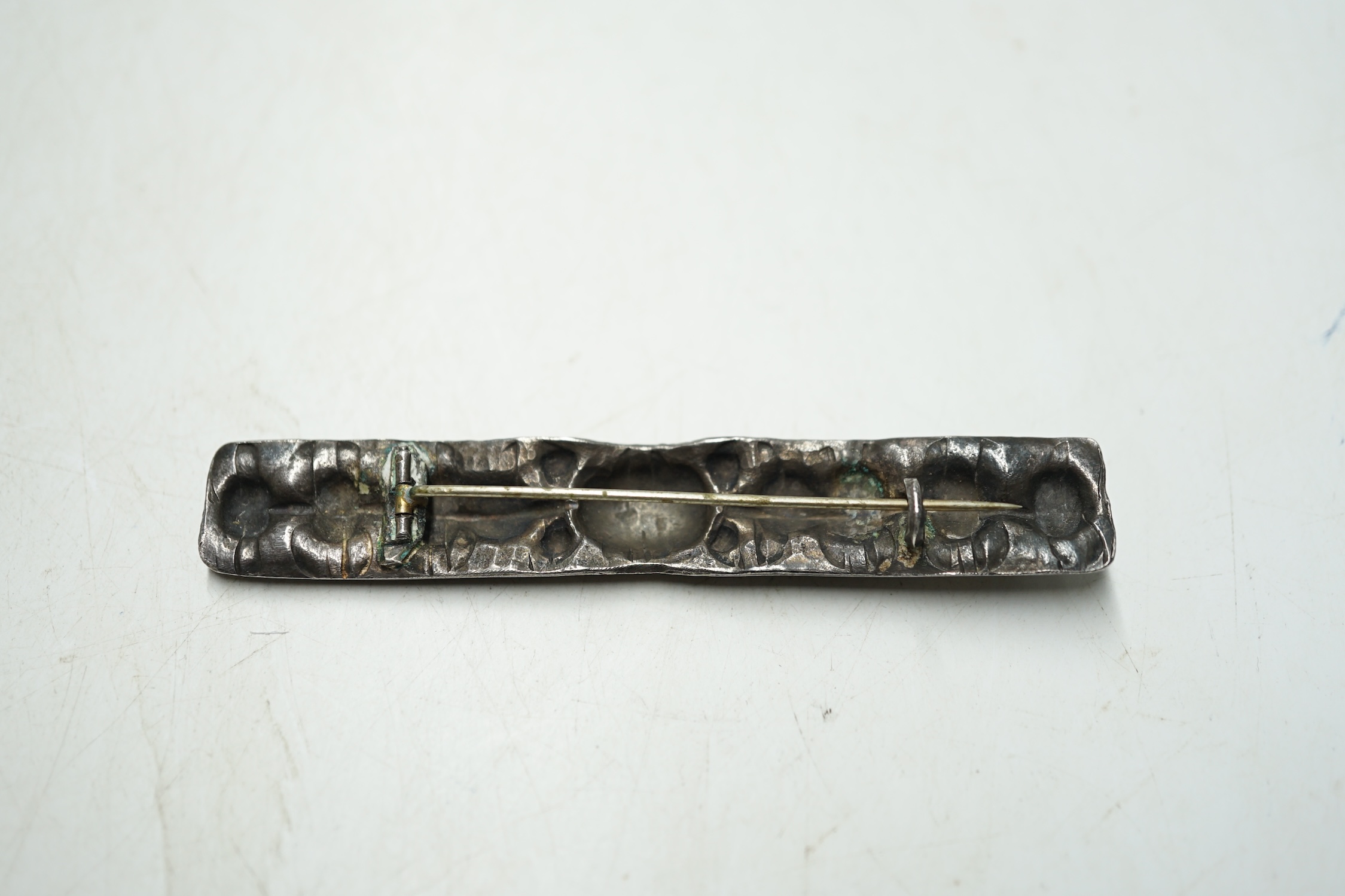 A white metal rectangular brooch, with embossed decoration, 90mm. Condition - fair